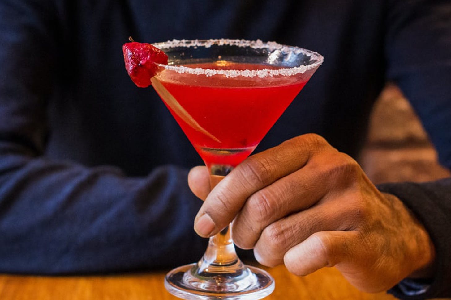 Man holding a pink berry margarita.